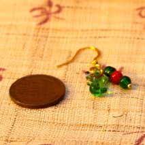 Tiny glass Christmas frog earrings – $6